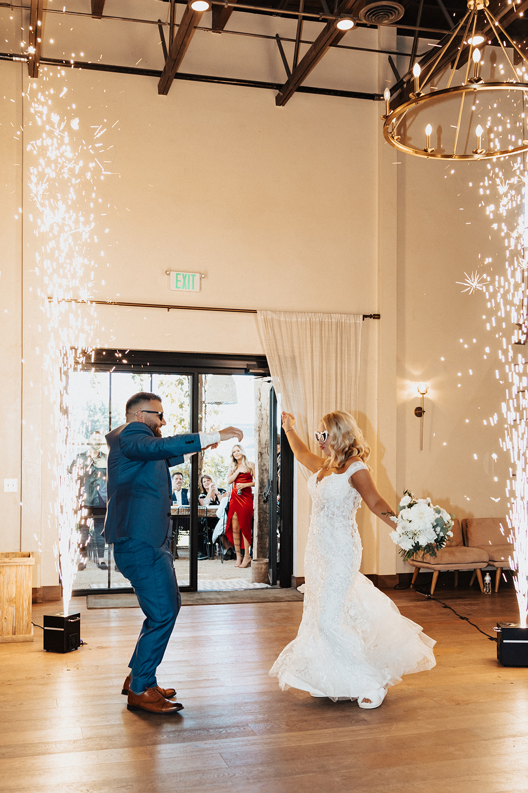 Sammy and Jake celebrating their wedding between two cold spark fountains.